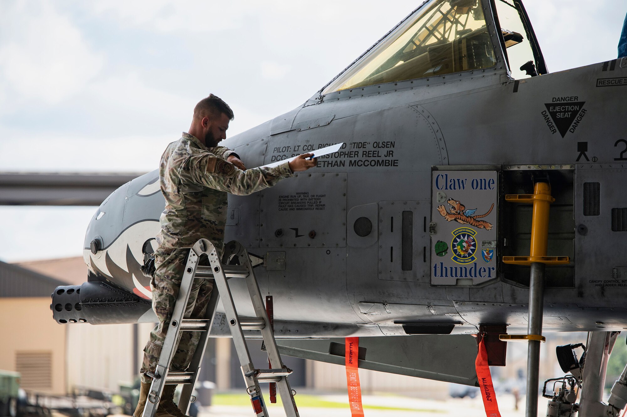 U.S. Air Force Senior Airman Christopher Reel, 74th Fighter Squadron dedicated crew chief, removes the name of the previous squadron commander from the 74th FS flagship A-10C Thunderbolt II