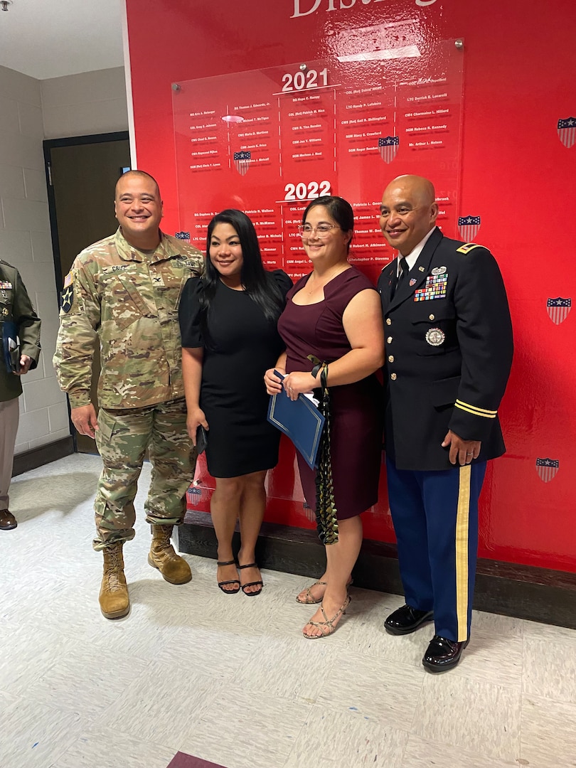 From left to right, CW4 Bernard L. Aguon poses for photograph with Col. Richard Cruz, Crystal Cruz, and his wife Jennifer Aguon, at the AG Regimental Corps Wall of Fame, Soldier Support Institute Fort Jackson, S.C., June 15, 2024.  CW4 Aguon was inducted into the AG Corps Hall of Fame as a Distinguished Member of the Corps for his HR accomplishments with the Integrated Personnel and Pay System - Army (IPPSA).