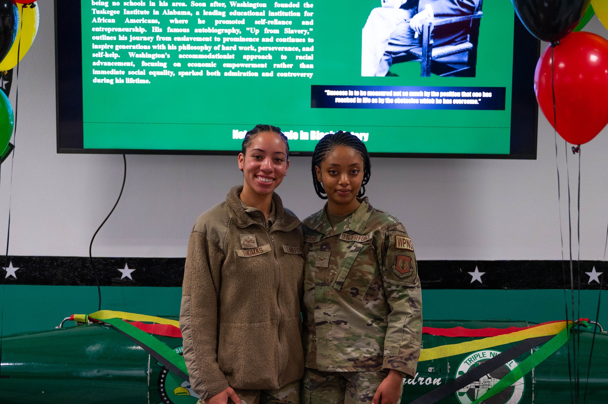 2 female airmen embrace and pose for a photo