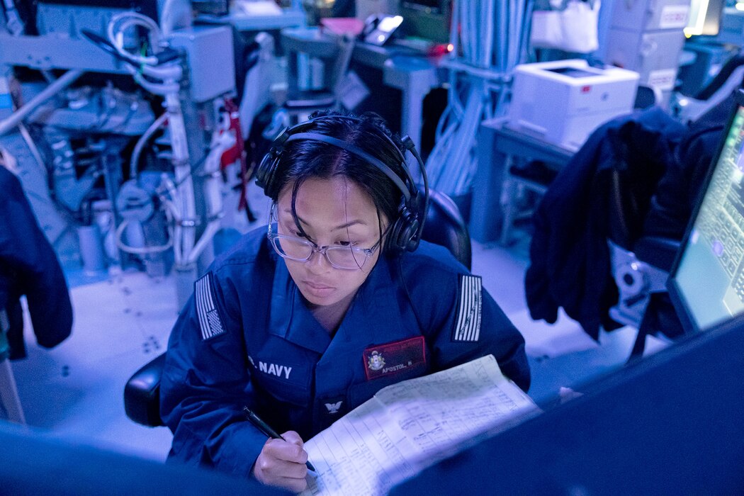 CTT Hannah Apostol stands watch in CIC aboard USS Rafael Peralta (DDG 115) in the Philippine Sea.