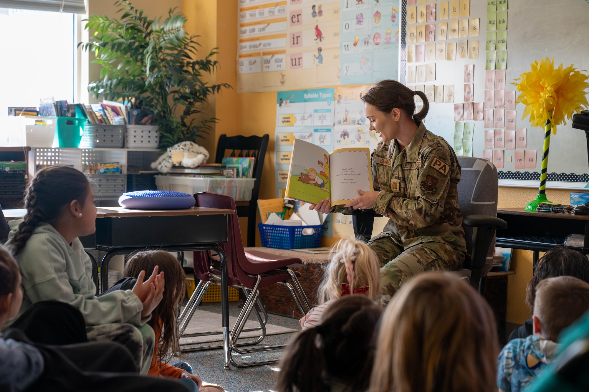 An Airmen reads to an elementary school class.