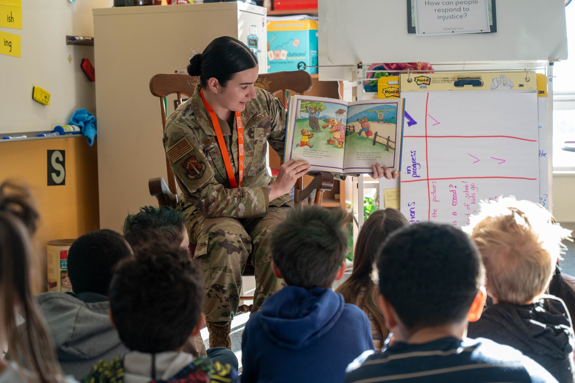 An Airmen reads to an elementary school class.