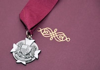 A close-up of the sterling silver medallion signifying membership in the Order of Military Medical Merit.