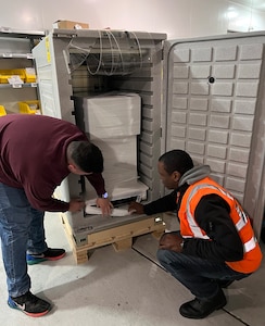Workers at the U.S. Army Medical Materiel Center-Europe load a shipment of refrigerated medical items into a new cold-chain management container designed to hold temperatures between 2 and 8 degrees Celsius. The rugged, battery-powered units feature a self-regulated refrigeration system that can hold temperatures for 48 hours or more, ensuring medications, vaccines and other medical supplies reach their destination ready to be used.