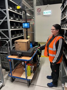 Jeanette Hoeh, a supply technician at the U.S. Army Medical Materiel Center-Europe, scans a box of medical supplies using a new scale system being piloted to streamline warehousing and distribution operations. The new “dimensioner” system incorporates a high-tech scale with optical features that can capture images and calculate the exact dimensions and weight of items being inventoried or readied for shipment.