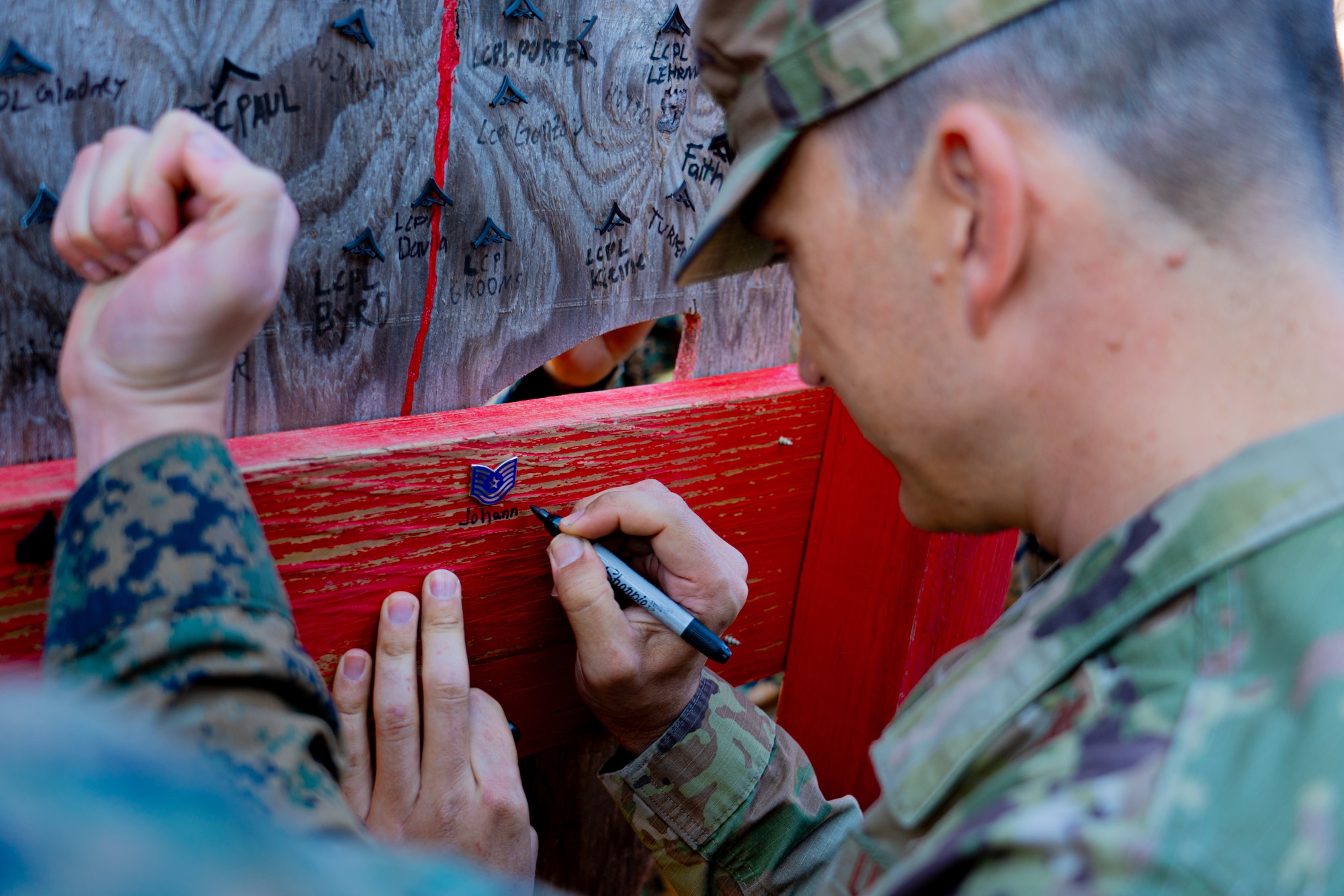 Airman writes on wood.