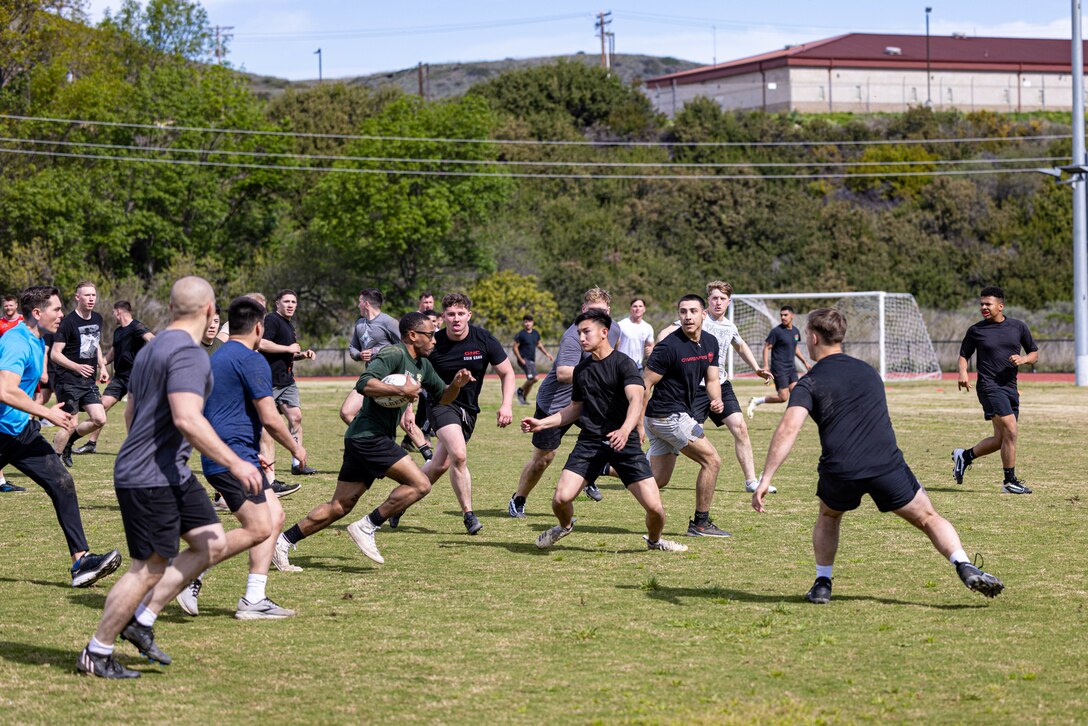 U.S. Marines with Marine Rotational Force – Darwin 24.3, participate in a rugby drill during a rugby clinic with the San Diego Legion rugby team at Marine Corps Base Camp Pendleton, California, Feb. 23, 2024. SD Legion was brought in to teach MRF-D 24.3 Marines about rugby, a sport that builds comradery and teamwork. Founded in 2017, the SD Legion is a San Diego base rugby union team with players from all over the world. (U.S. Marine Corps photo by Cpl. Juan Torres)