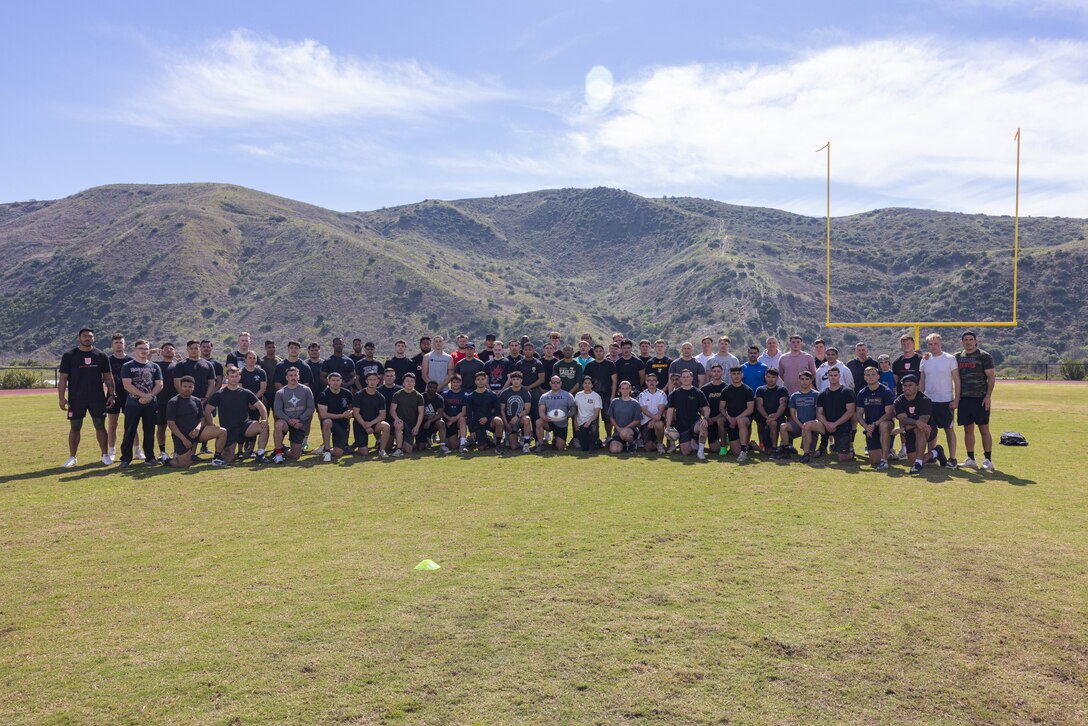 U.S. Marines with Marine Rotational Force – Darwin 24.3 and San Diego Legion rugby team pose for a group photo after a rugby clinic at Marine Corps Base Camp Pendleton, California, Feb. 23, 2024. SD Legion was brought in to teach MRF-D 24.3 Marines about rugby, a sport that builds comradery and teamwork. Founded in 2017, the SD Legion is a San Diego based rugby union team with players from all over the world. (U.S. Marine Corps photo by Cpl. Juan Torres)