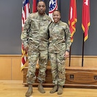 photo of women wearing U.S. Army uniform with a man wearing uniforms.