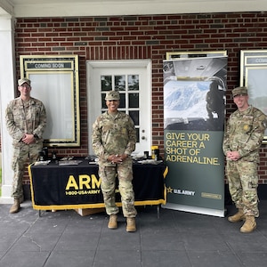 photo of women wearing U.S. Army uniform with two men wearing uniforms.