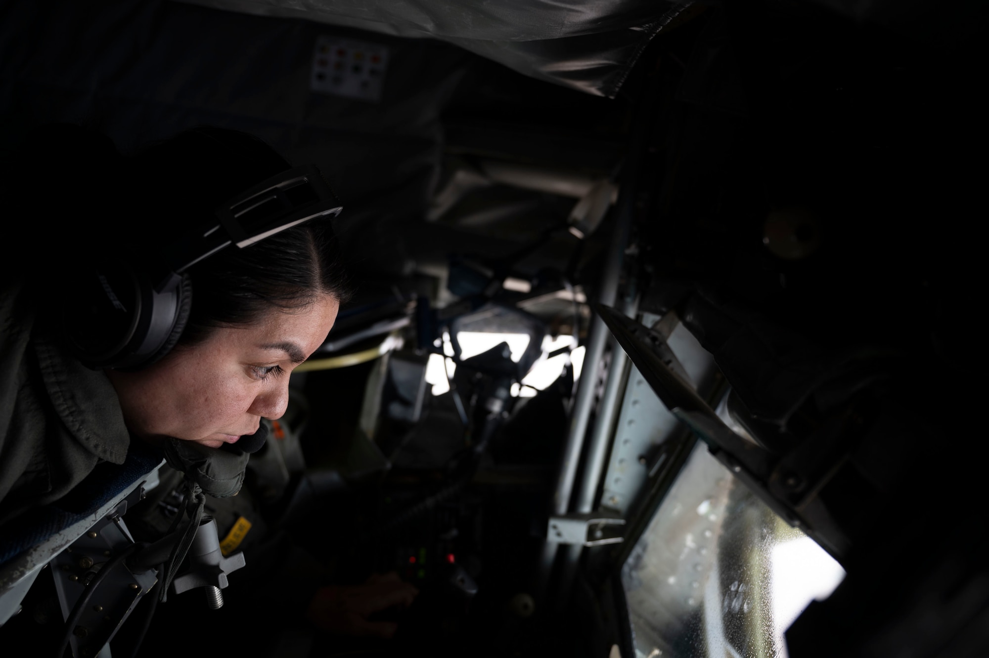 Senior Airman Gabriella Martinez, 350th Air Refueling Squadron boom operator, sits in the boom pod of a KC-135 Stratotanker during EXPLODEO Feb. 26, 2024, over the Midwestern United States. EXPLODEO was a McConnell exercise that tested the 22nd and 931st Air Refueling Wings’ ability to rapidly deploy and employ into a theater. (U.S. Air Force photo by Airman 1st Class Gavin Hameed)