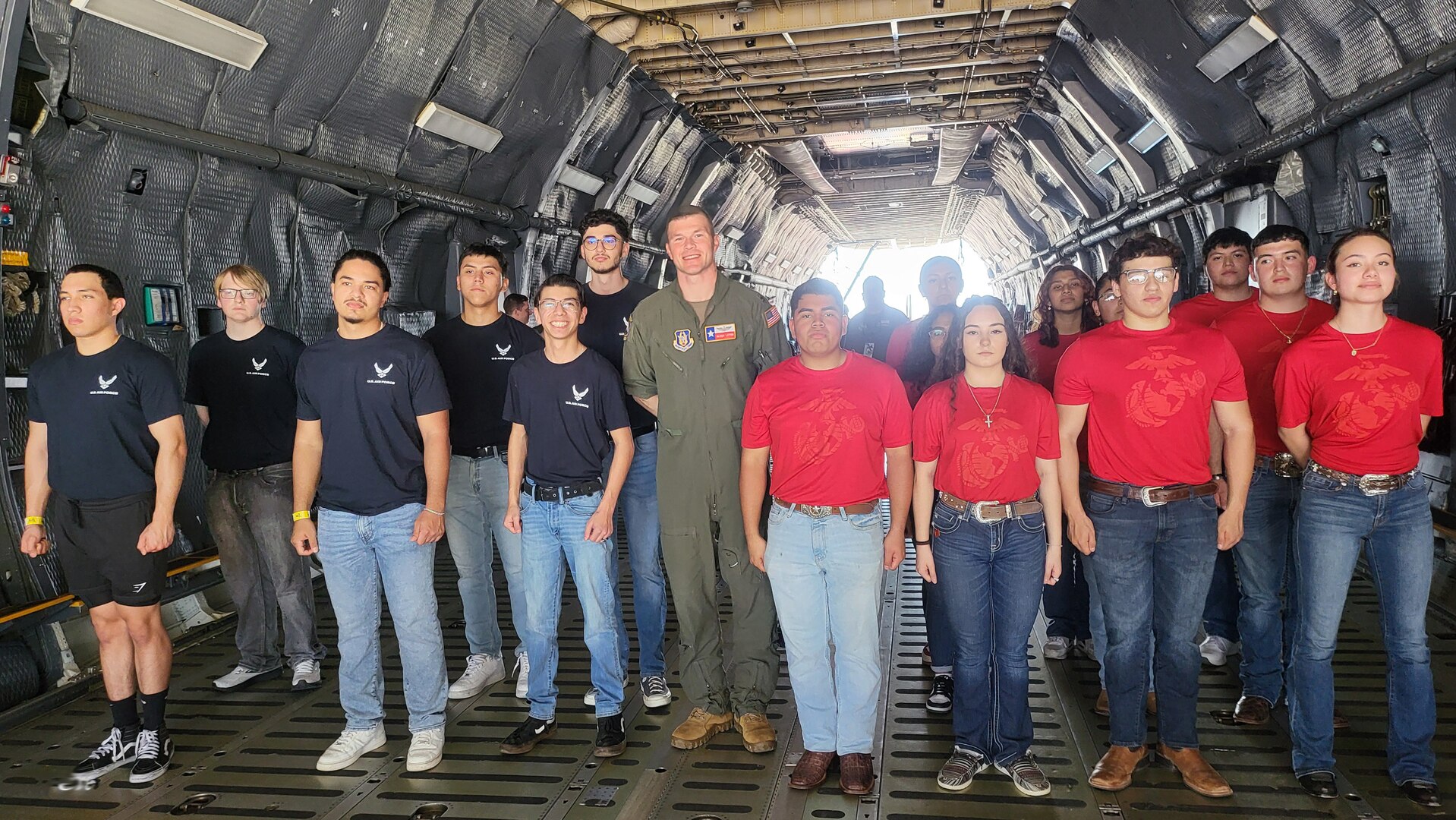 Eight U.S. Air Force recruits and eight U.S. Marine Corps recruits prepare to do their initial swearing  in ceremony on the ramp of a C-5M Super Galaxy at the Washington’s Birthday Celebration Association Stars and Stripes Air Show Spectacular on the flightline at the Laredo International Airport in Laredo, Texas Feb. 25, 2024.