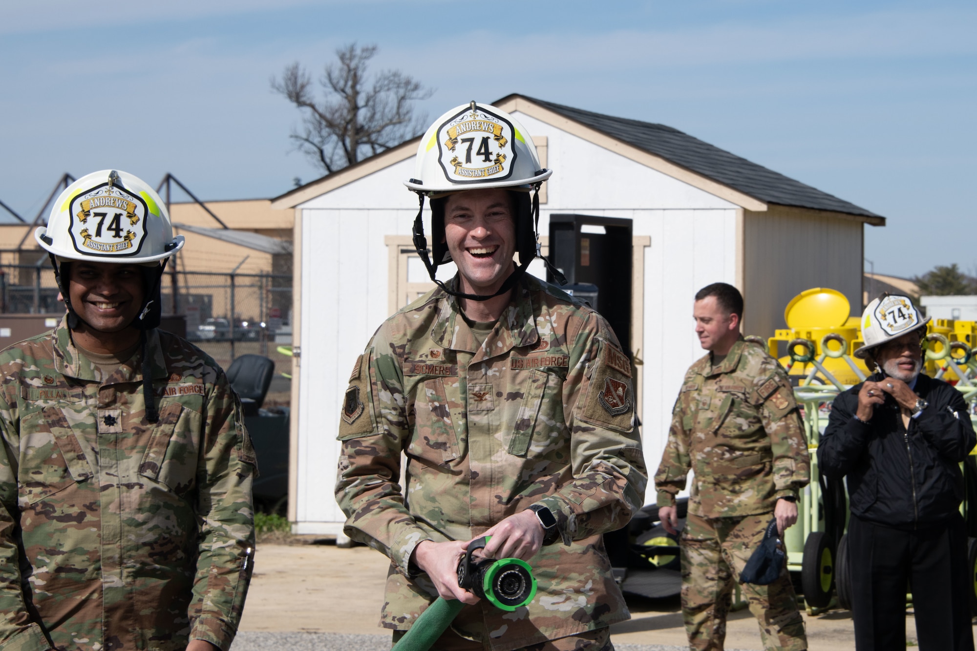 U.S. Air Force Col. Nate Somers, 316th Mission Support Group commander, and Col. Trivendhiran Pillai, 316th Comptroller commander, preparate to spray down two new fire trucks during a “Push-In” ceremony at Joint Base Andrews, Md., March 1, 2024.