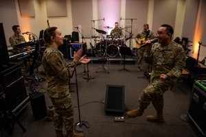 Airman tunes a musical instrument.