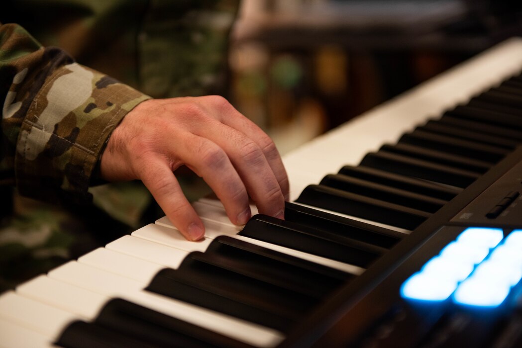Close up of hand playing the piano.