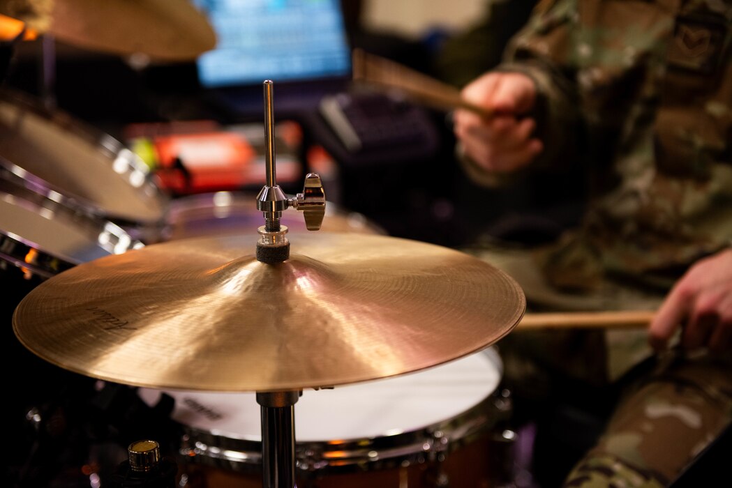 Close up of symbol of a drum set being played during a rehearsal.