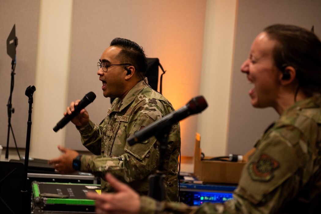 Vocalists sing during a rehearsal.