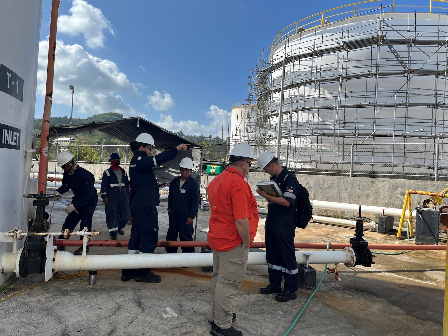 U.S. Coast Guard members observe a Government-Initiated Unannounced Exercise (GIUE) at Mobil Saipan on Feb. 29, 2024, in Saipan, Commonwealth of the Northern Mariana Islands. The primary goal of a GIUE is to ensure that the plan holder can effectively implement their response plan during a marine environmental response scenario. (U.S. Coast Guard photo by Lt. Justin Miller)