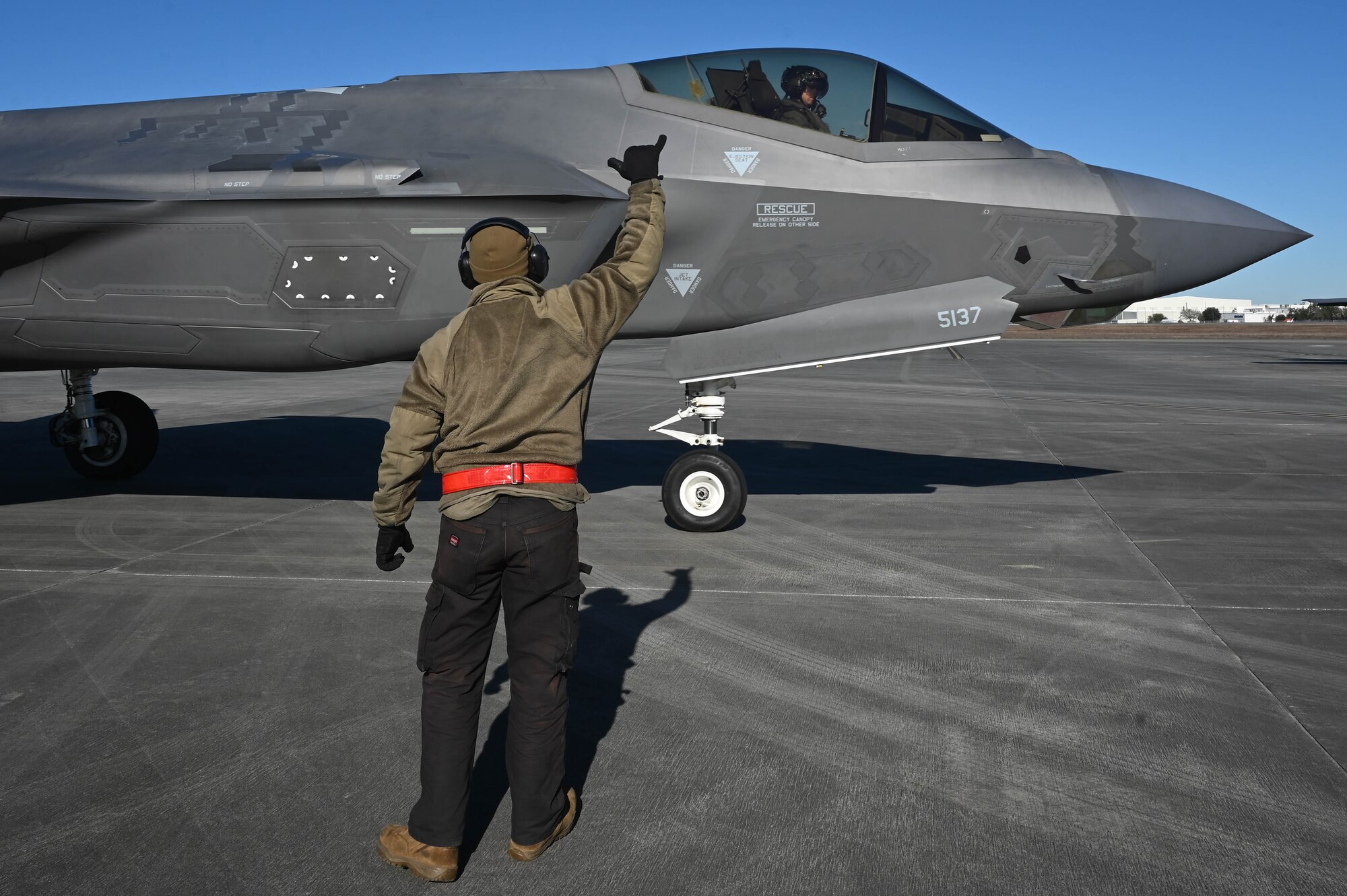 Airman 1st Class Calvin Walls, 60th Aircraft Maintenance Unit crew chief, marshals an F-35A Lightning II for takeoff at Savannah Air National Guard Base, Georgia, Feb. 14, 2024.