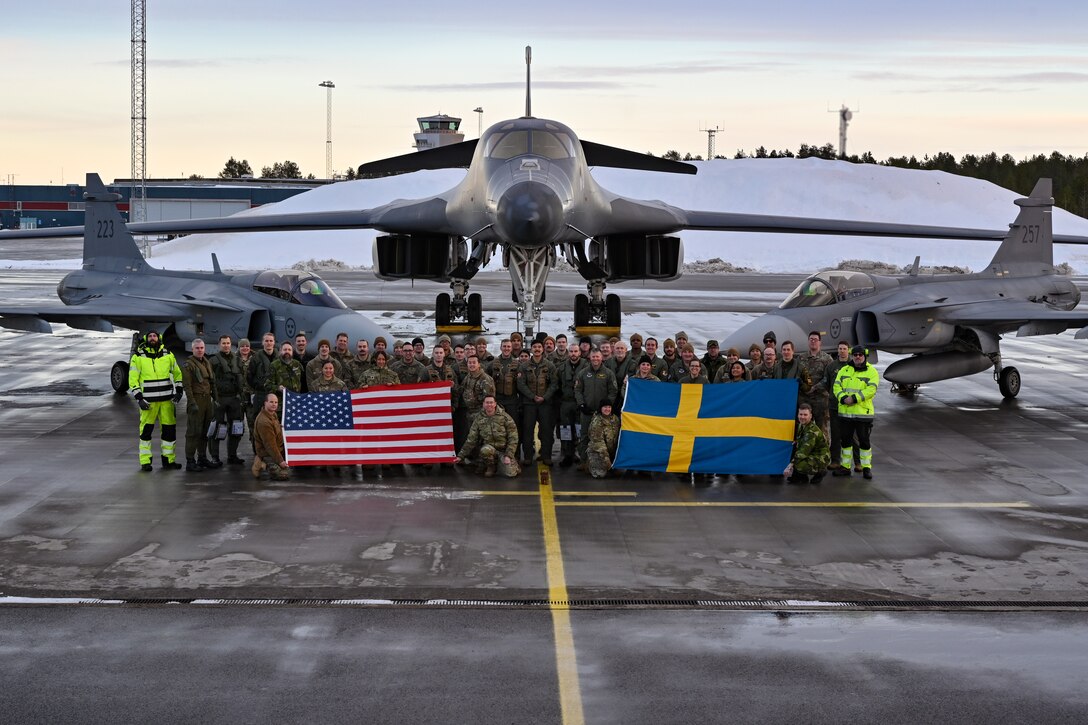 U.S. Air Force Airmen assigned to the 28th Bomb Wing, Ellsworth Air Force Base, South Dakota, pose for a group photo alongside Swedish military personnel in front of a B-1B Lancer and two Saab JAS 39 Gripens at Luleå-Kallax Air Base, Sweden, Feb. 26, 2024, during Bomber Task Force 24-2. These BTF missions are representative of the U.S.' extended deterrent commitment to its Allies and partners and enhance regional security. BTF operations provide U.S. leaders with strategic options to assure Allies and partners, while deterring potential adversary aggression across the globe. (U.S. Air Force photo by Staff Sgt. Jake Jacobsen)