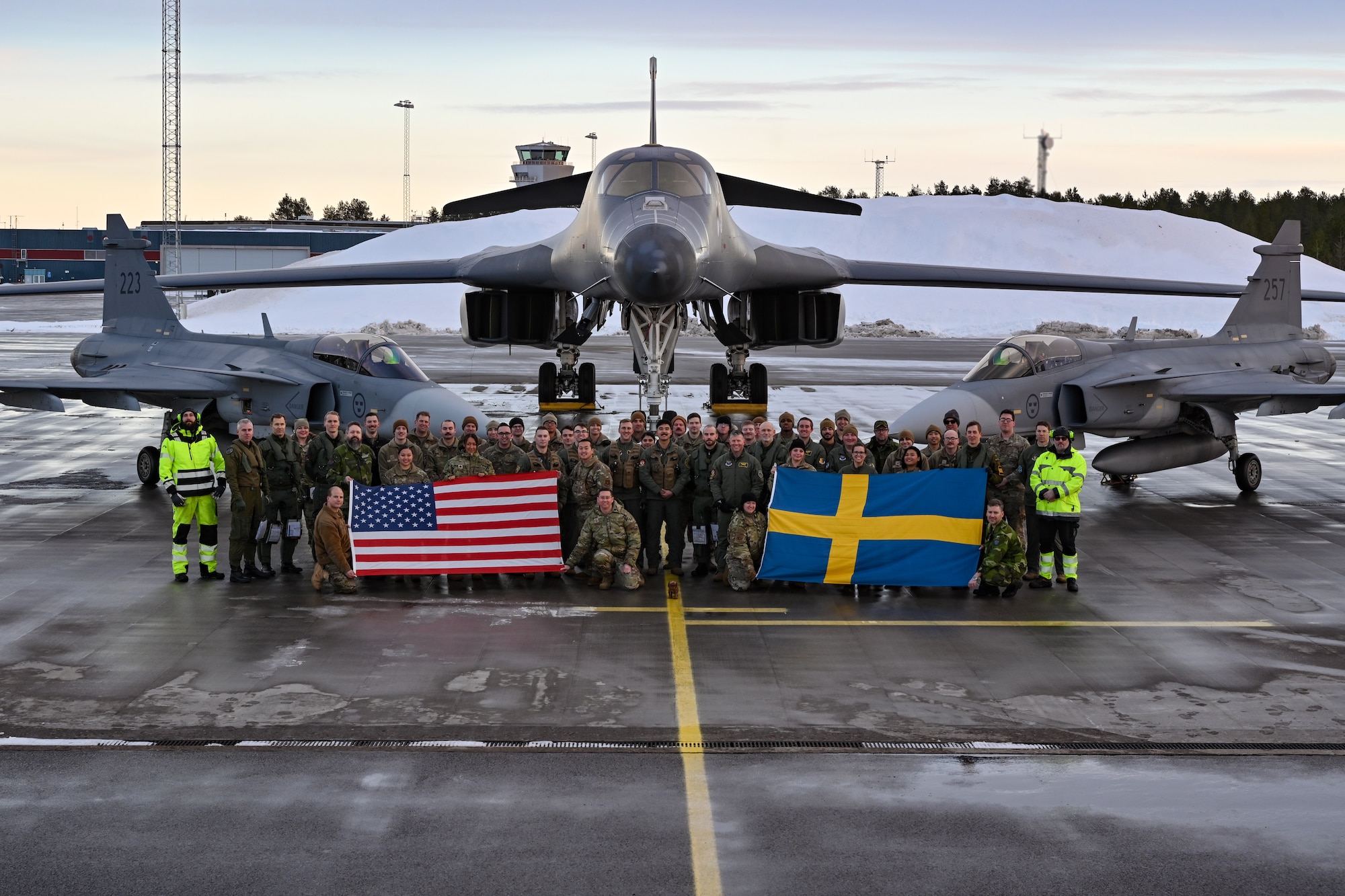 U.S. Air Force Airmen assigned to the 28th Bomb Wing, Ellsworth Air Force Base, South Dakota, pose for a group photo alongside Swedish military personnel in front of a B-1B Lancer and two Saab JAS 39 Gripens at Luleå-Kallax Air Base, Sweden, Feb. 26, 2024, during Bomber Task Force 24-2. These BTF missions are representative of the U.S.' extended deterrent commitment to its Allies and partners and enhance regional security. BTF operations provide U.S. leaders with strategic options to assure Allies and partners, while deterring potential adversary aggression across the globe. (U.S. Air Force photo by Staff Sgt. Jake Jacobsen)