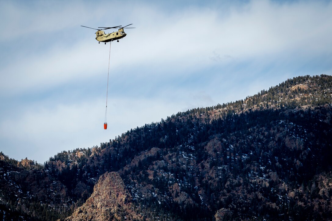 Firefighters from the U.S. Air Force Academy, Fort Carson, Colo., and the Colorado Springs Fire Department dump water from air assets