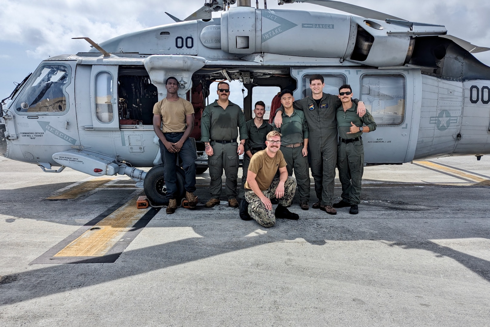 In a display of interagency cooperation, a commercial mariner in urgent need of medical care was safely evacuated from his vessel 100 nautical miles offshore to Guam on March 2, 2024, thanks to the actions of the U.S. Coast Guard and the U.S. Navy's Helicopter Sea Combat Squadron 25 (HSC-25). The crew takes a moment for a photo after the medical evacuation: Lt. Kolby Ingram, Lt. Andrew Chung, AWS2 Blake Clark, AWS3 Ethan Kubat, and HM1 Christopher Finley. (U.S. Navy photo)