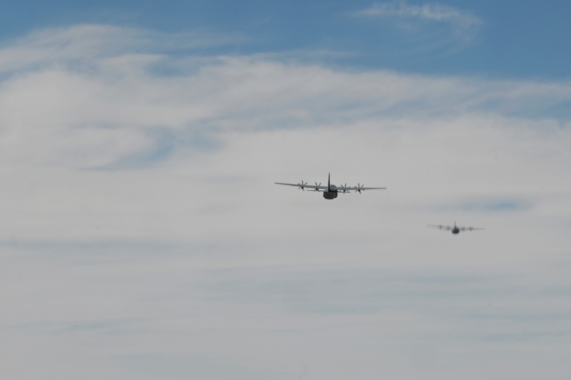Two U.S. Air Force C-130J Super Hercules aircraft fly in formation in preparation to release 66 bundles of humanitarian aid over Gaza.