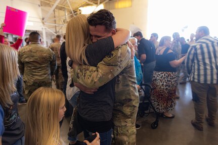 A member of Task Force Tomahawk reunites with their family during a welcome home ceremony at Will Rogers Air National Guard Base in Oklahoma City, Feb. 24, 2024. Task Force Tomahawk returned from a nine-month deployment in support of Combined Joint Task Force - Horn of Africa, where the Citizen-Soldiers provided security at multiple sites across the Horn of Africa as well as manned the East African Response Force. (Oklahoma National Guard photo by Staff Sgt. Reece Heck)