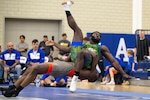 Army Spc. Timothy Young throws Air Force Staff Sgt. Diante Cooper out of bounds during the Greco-Roman style wrestling portion of  the 2024 Armed Forces Wrestling Championship at the U.S. Air Force Academy in Colorado Springs, Colo. March 2, 2024. (DoD photo by EJ Hersom)