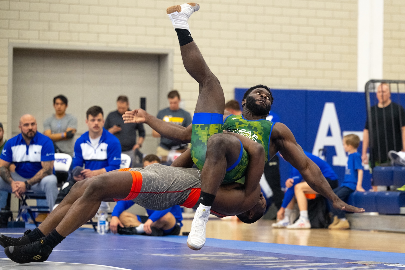 Army Spc. Timothy Young throws Air Force Staff Sgt. Diante Cooper out of bounds during the Greco-Roman style wrestling portion of  the 2024 Armed Forces Wrestling Championship at the U.S. Air Force Academy in Colorado Springs, Colo. March 2, 2024. (DoD photo by EJ Hersom)