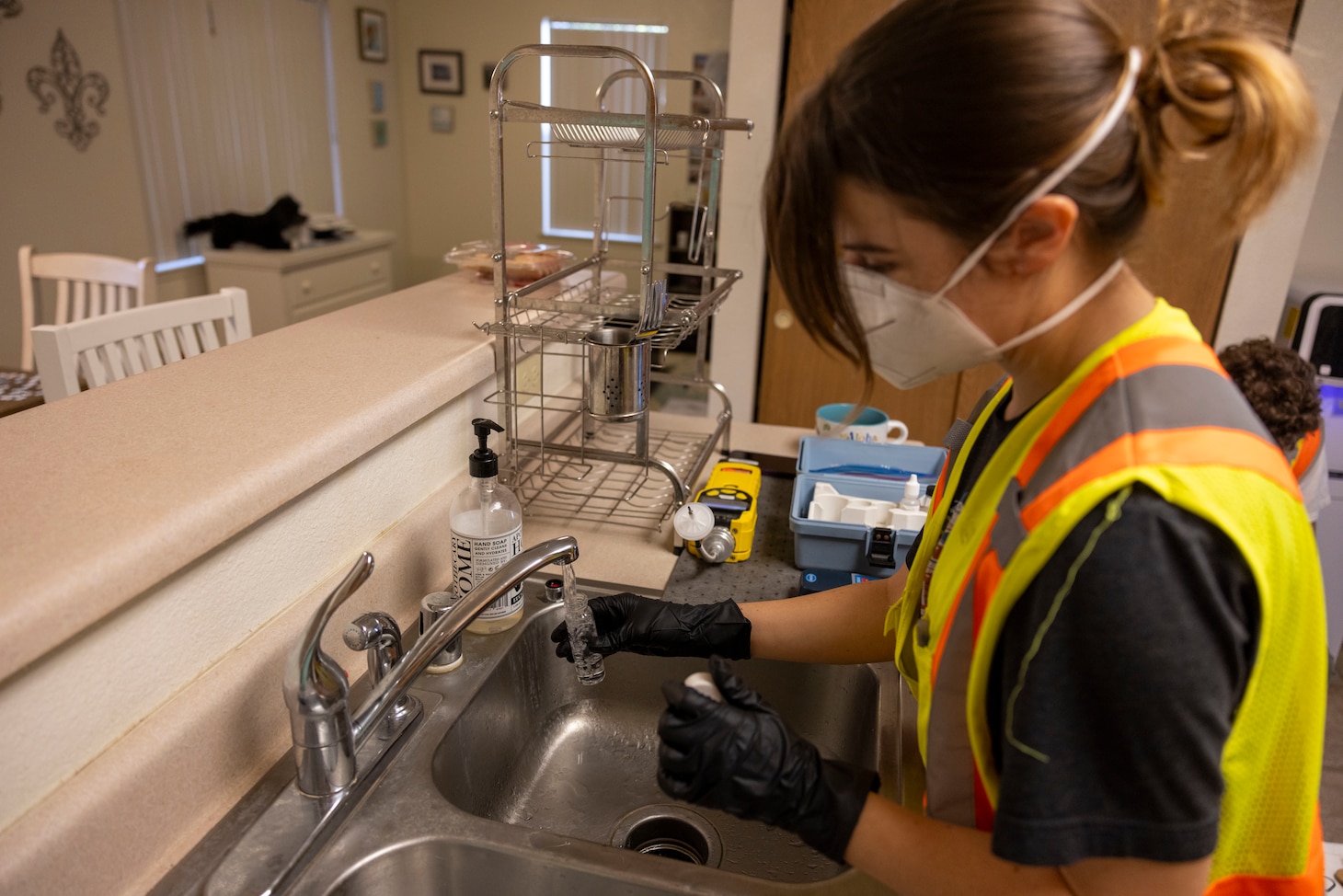 Hannah Brumby, a Navy contractor, collects water samples as part of the Navy’s Drinking Water Long-Term Monitoring program in Honolulu, Hawaii, Feb. 13.