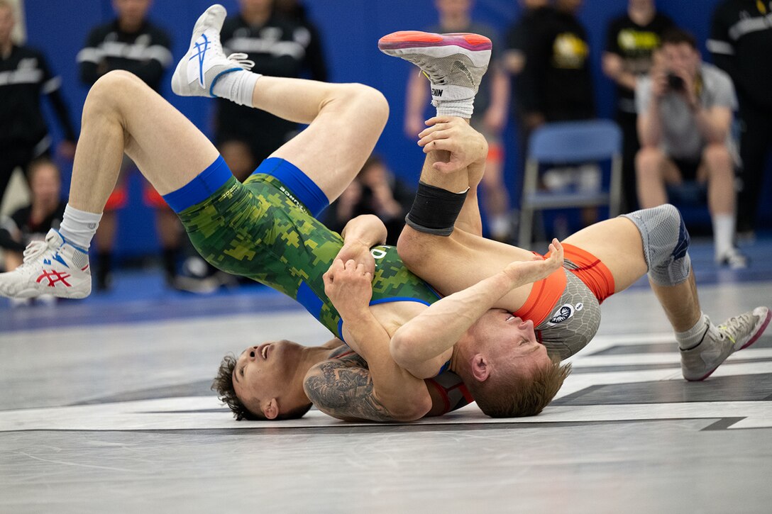 Army Spc. William Sullivan scrambles with Senior Airman Mitch Brown during the freestyle portion of the 2024 Armed Forces Wrestling Championship at the U.S. Air Force Academy in Colorado Springs, Colo. March 3, 2024. (DoD photo by EJ Hersom)