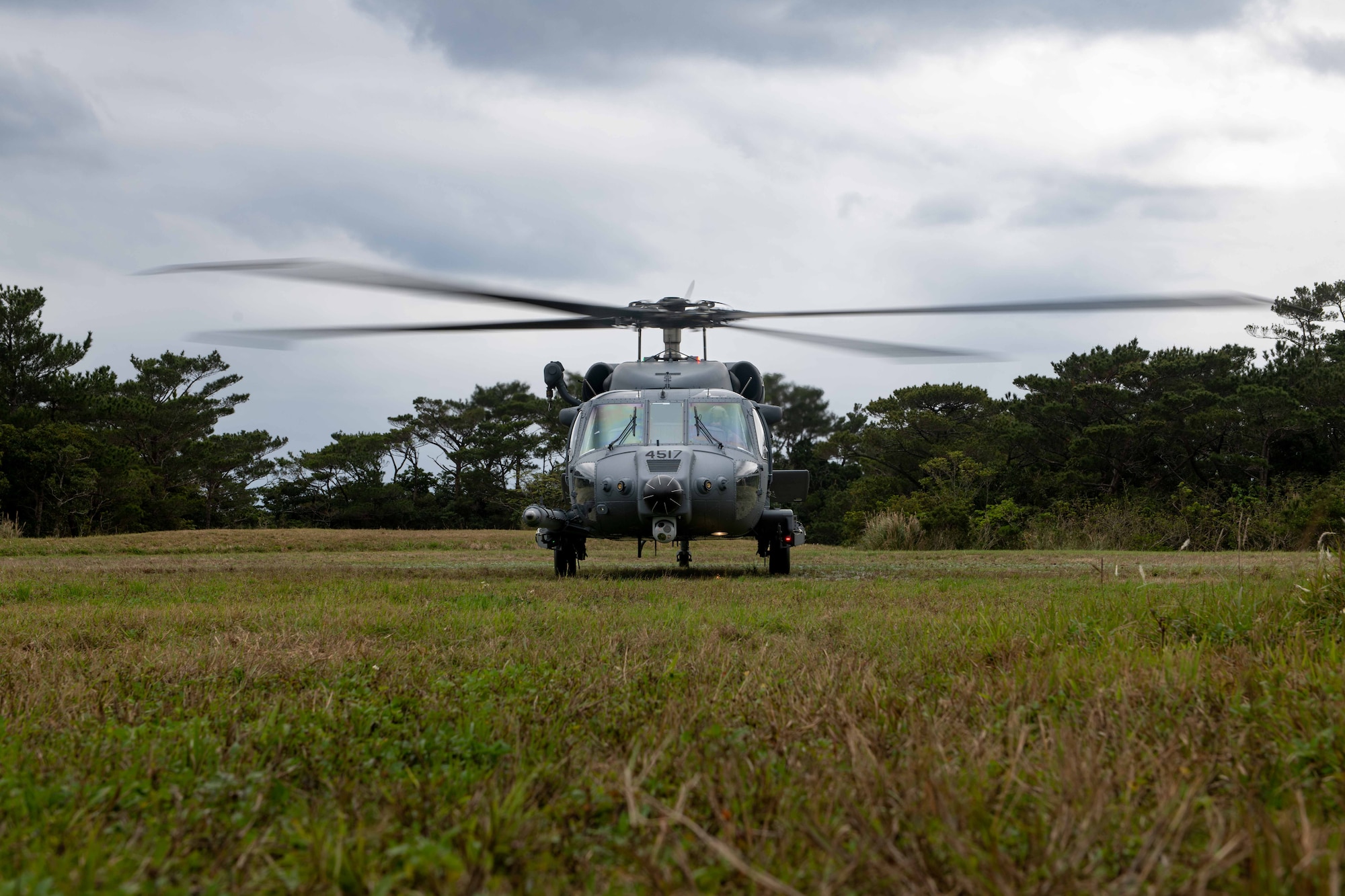 Parked HH-60W in a grass field for a training exercise