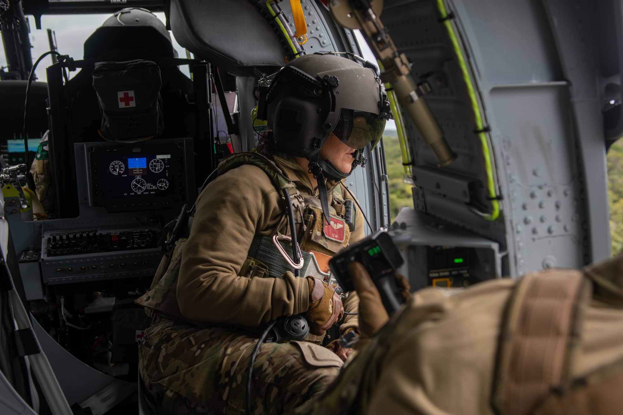Aircrew pilot assisting her counterpart through coms.
