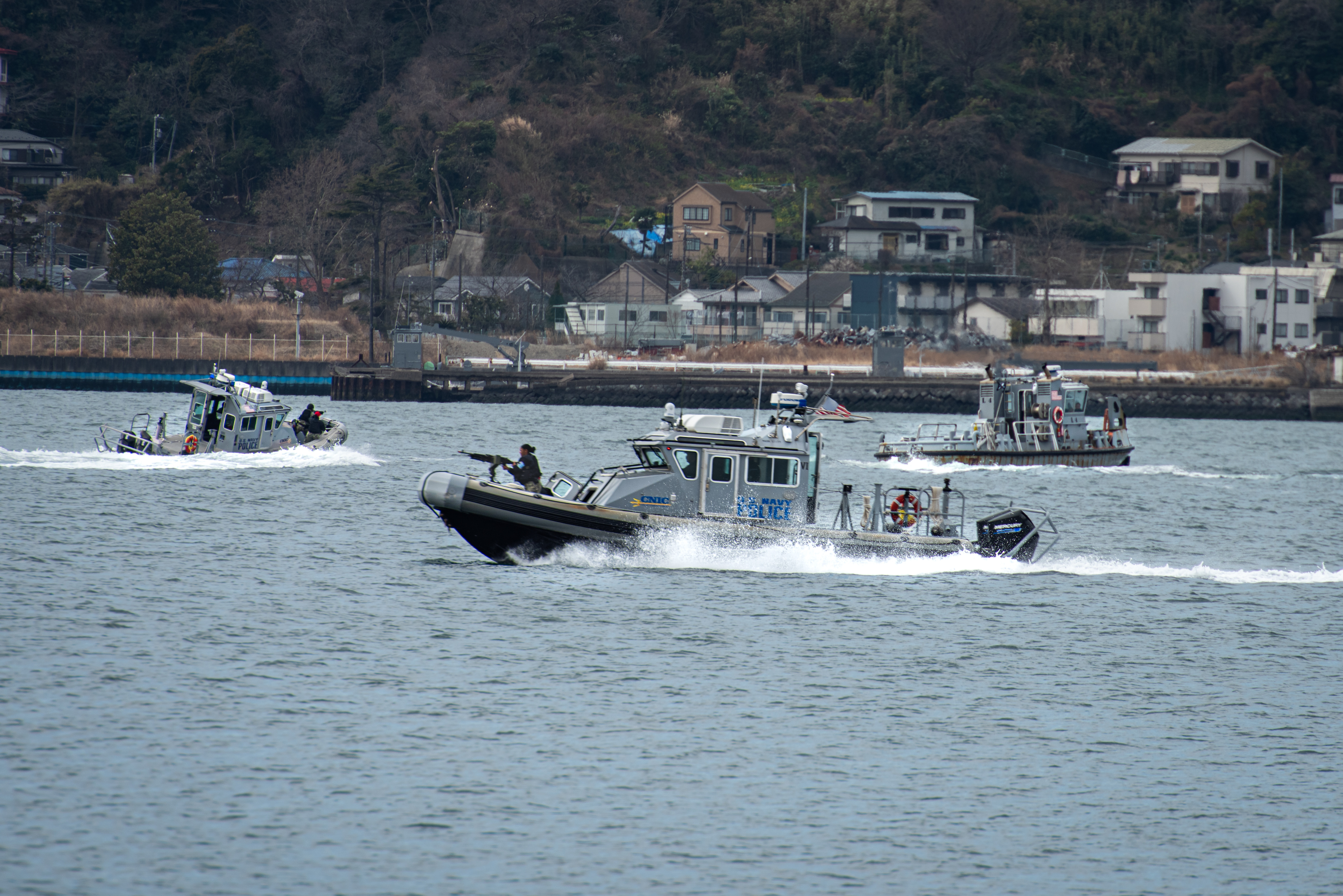 Commander, Fleet Activities Yokosuka (CFAY) Security Forces Harbor Patrol Unit challenge a contact of interest during a simulated small boat probe attack