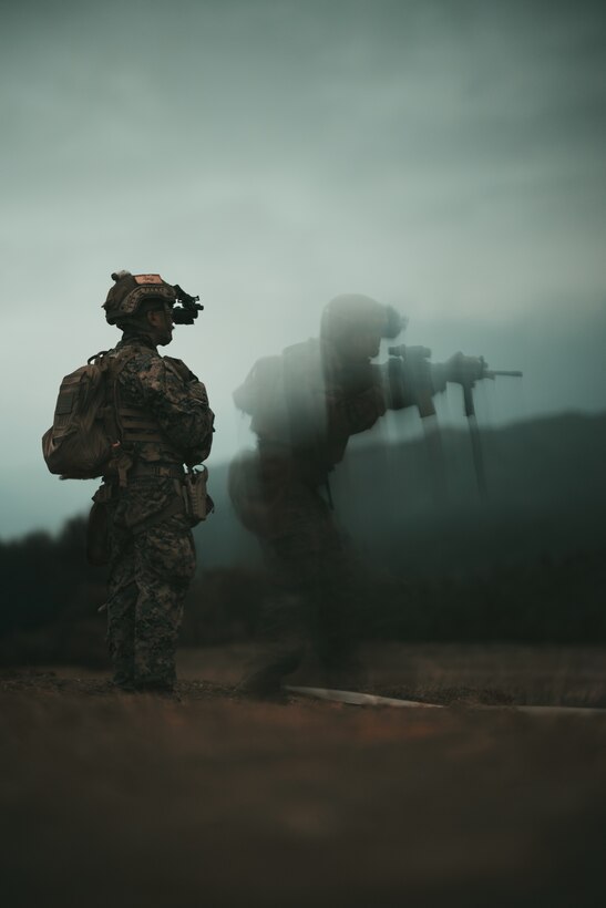 U.S. Marine Corps Lance Cpl. Christian Montemayor, left, a fire support Marine with 5th Air Naval Gunfire Liaison Company, III Marine Expeditionary Force Information Group, observes a Marine performing a nighttime course of fire during a Marine Corps Combat Marksmanship Program range as part of 2nd Brigade Platoon’s field exercise on Camp Hansen, Okinawa, Japan, Feb. 14, 2024. This CMP allows Marines to maintain weapon proficiency by engaging targets in a competitive environment with primary and secondary weapon systems.  5th ANGLICO Marines refined their marksmanship fundamentals through advanced marksmanship training which enhanced their lethality. Montemayor is a native of San Diego. (U.S. Marine Corps photo by Staff Sgt. Manuel A. Serrano)