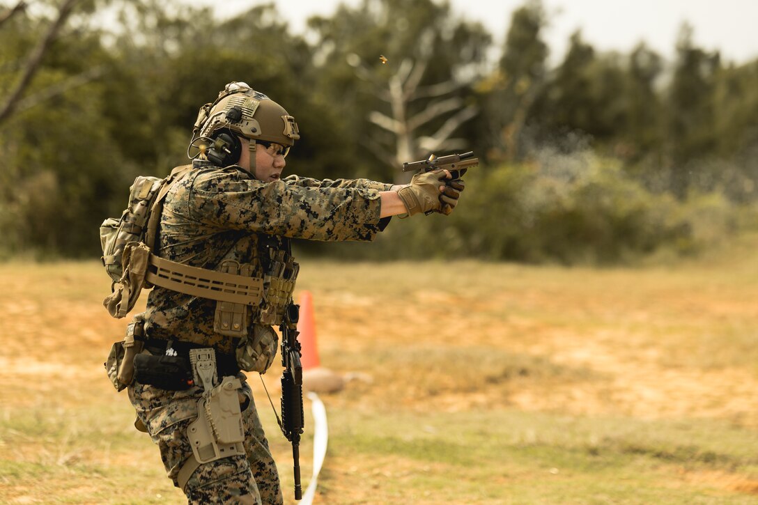 U.S. Marine Corps Staff Sgt. Sung Shin, an fires and effects integrator, with 5th Air Naval Gunfire Liaison Company, III Marine Expeditionary Force Information Group, fires a M18 service pistol during a Combat Marksmanship Program range as part of 2nd Brigade Platoon’s field exercise on Camp Hansen, Okinawa, Japan, Feb. 14, 2024. CMP allows Marines to maintain weapon proficiency by engaging targets in a competitive environment with primary and secondary weapon systems. 5th ANGLICO Marines refined their shooting fundamentals through advanced marksmanship training, enhancing their lethality. Shin is a native of Duluth, GA. (U.S. Marine Corps photo by Staff Sgt. Manuel A. Serrano)