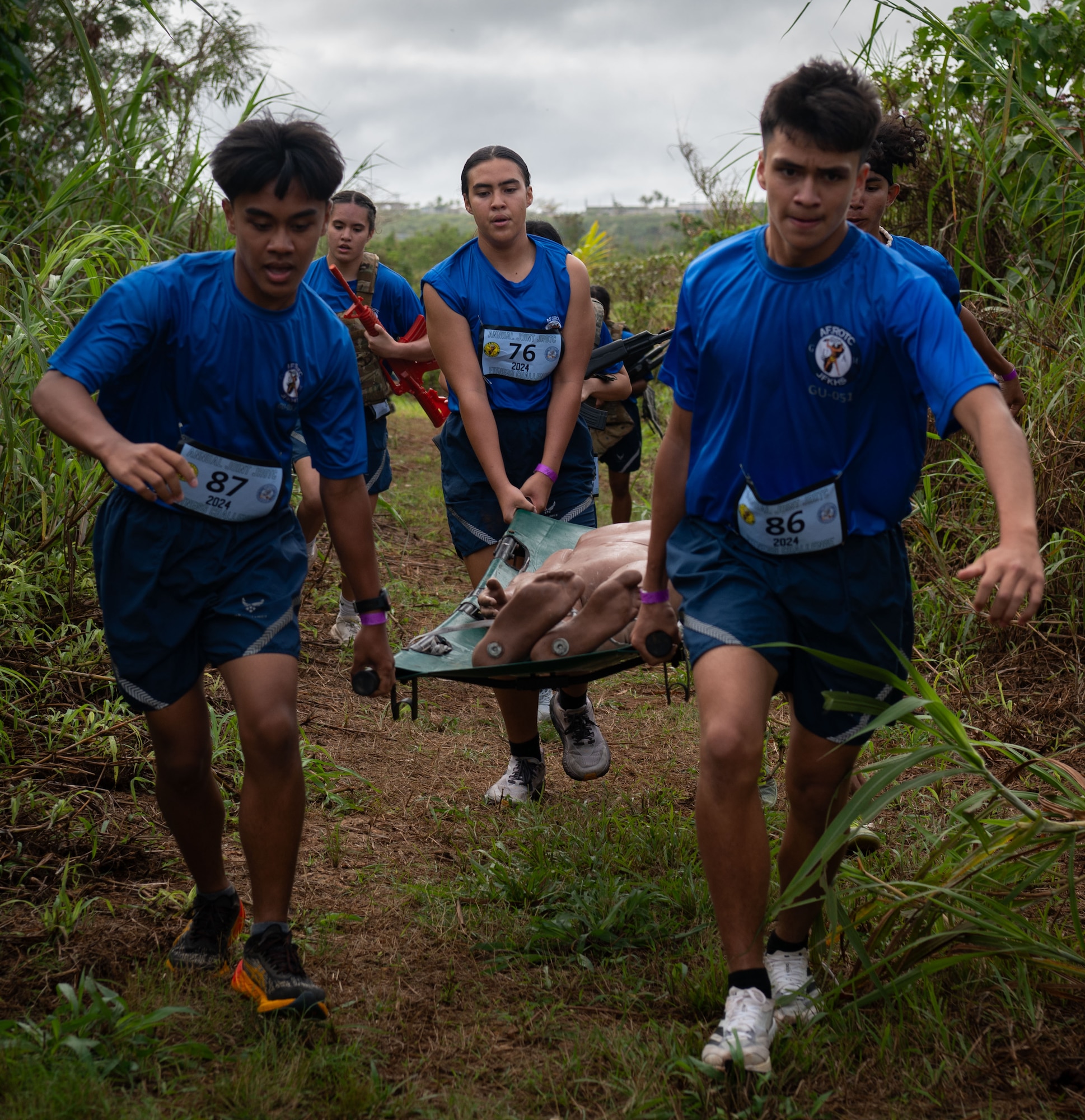 U.S. Air Force Junior Reserve Officer Training Corps cadets from John F. Kennedy High School, Guam, carry a stretcher with a dummy in it during the 3rd annual JROTC Fitness Challenge hosted at JFKHS, Feb. 24, 2023. Most of the fitness challenge were actual tests that are conducted during DoD physical fitness assessments, i.e. push-ups and sit-ups. The addition of the equipment trail run challenge was to educate the cadets on what working in/carrying military equipment would feel like in the field. This event is also the only pure team event in which the team's fitness score is based on the whole team crossing the finish line. (U.S. Air Force photo by Staff Sgt. Pedro Tenorio)