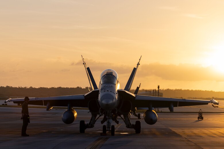 U.S. Marine Corps Cpl. Tyler Hunt, a fixed-wing aircraft mechanic with Marine Fighter Attack Squadron (VMFA) 232, prepares to send off an F/A-18D Hornet aircraft at Andersen Air Force Base, Guam, Feb. 1, 2024. Nicknamed the “Red Devils,” VMFA-232 traveled from Marine Corps Air Station Iwakuni, Japan to Guam as a part of their Aviation Training Relocation Program deployment to train multilaterally with allies and partners, and enhance the squadron’s combat readiness. (U.S. Marine Corps photo by Sgt. Jose Angeles)