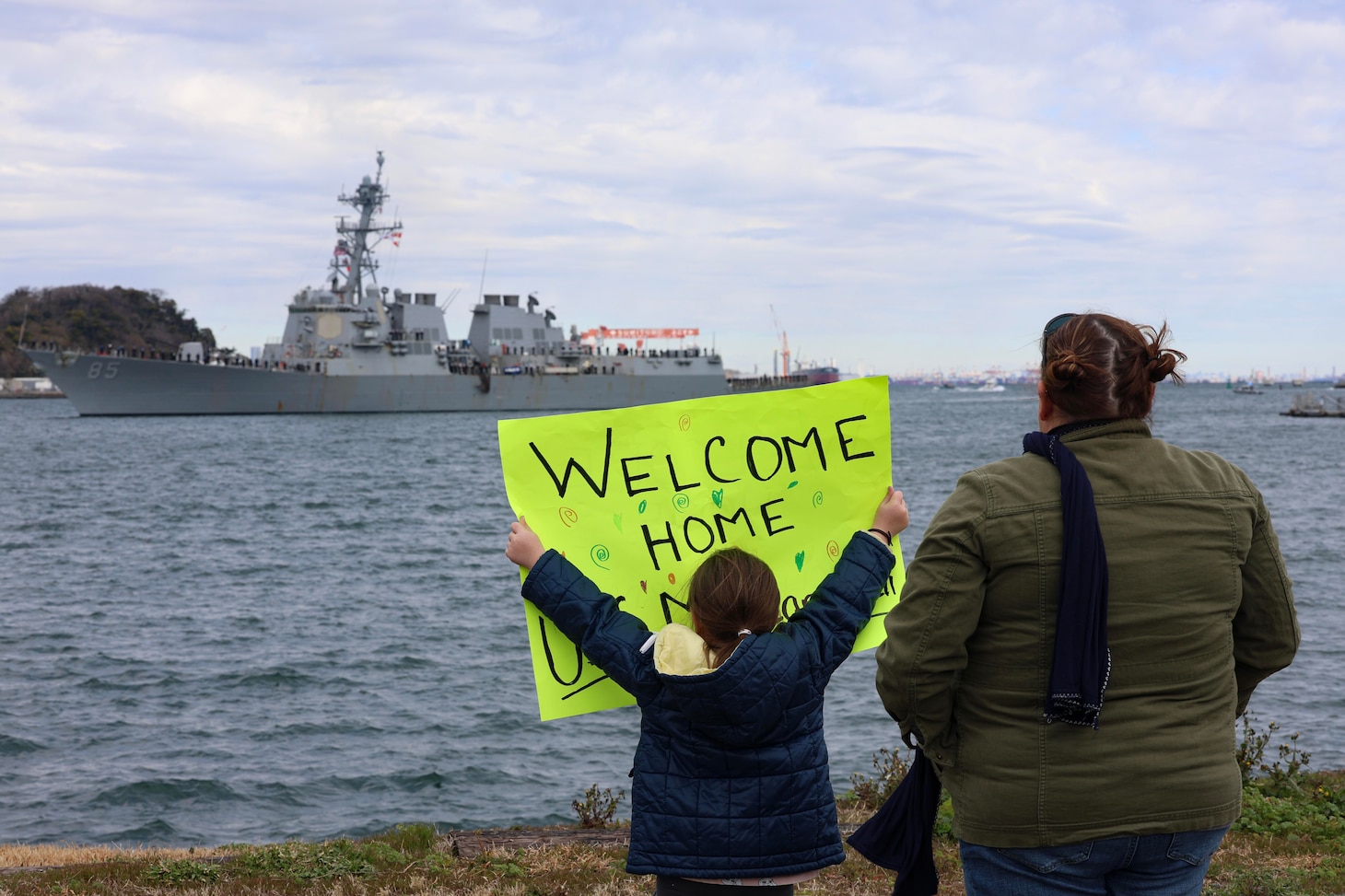 YOKOSUKA, Japan (March 2, 2024) – Family members await the arrival of the Arleigh Burke-class guided-missile destroyer USS McCampbell (DDG 85) as the ship returns to Commander, Fleet Activities Yokosuka, March 2, after a 17-month Depot Modernization Period in Portland, Oregon. McCampbell is forward-deployed and assigned to Destroyer Squadron (DESRON) 15, the Navy’s largest DESRON and the U.S. 7th Fleet’s principal surface force. (U.S. Navy photo by Mass Communication Specialist 1st Class Greg Johnson)