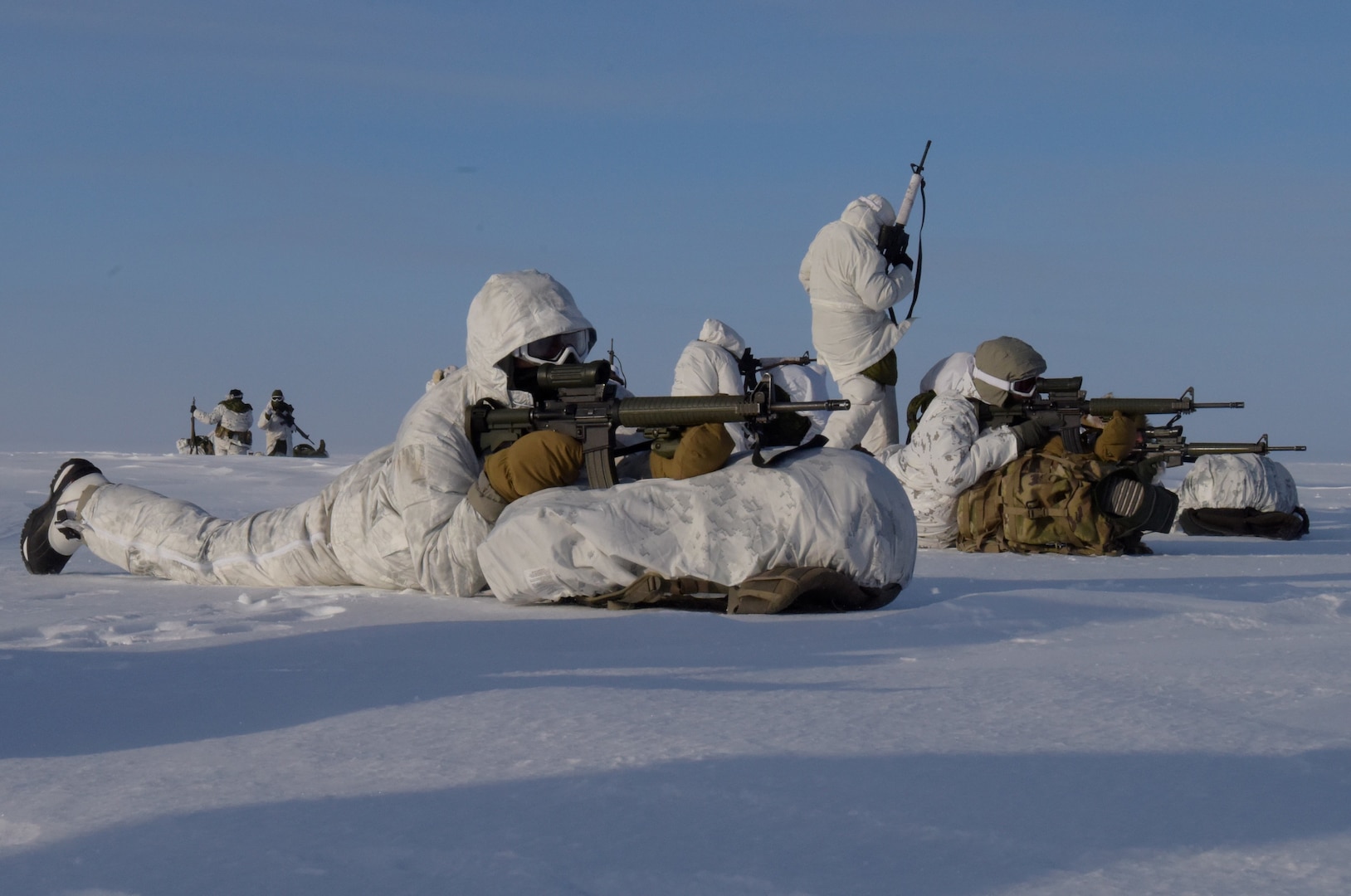 U.S. Army and Canadian Soldiers observe and secure the insertion area after disembarking from an LC-130 Hercules skiplane of the 109th Airlift Wing, New York Air National Guard, on frozen oceanic Arctic ice near Cornwallis Island, Nunavut, Canada, March 15, 2023. U.S. and Canadian Soldiers and U.S. Airmen are participating in Guerrier Nordique 24 to get experience operating tactically in the high Arctic.