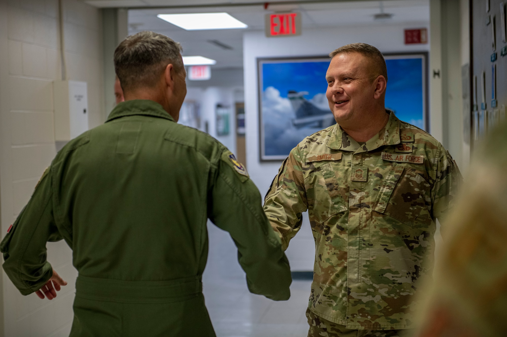 U.S. Air Force Lt. Gen. Steven S. Nordhaus, 1st Air Force commander, shakes hands with U.S. Air Force Senior Master Sgt. Peter Smith, the aircrew flight equipment superintendent, assigned to the Ohio National Guard’s 180th Fighter Wing, in Swanton, Ohio, Feb. 1, 2024. Nordhaus, who commanded the 180FW from 2011 to 2013, received a tour of the wing's facilities and discussed the 180FW’s Aerospace Control Alert mission during his visit. (U.S. Air National Guard photo by Airman 1st Class Nicholas Battani)