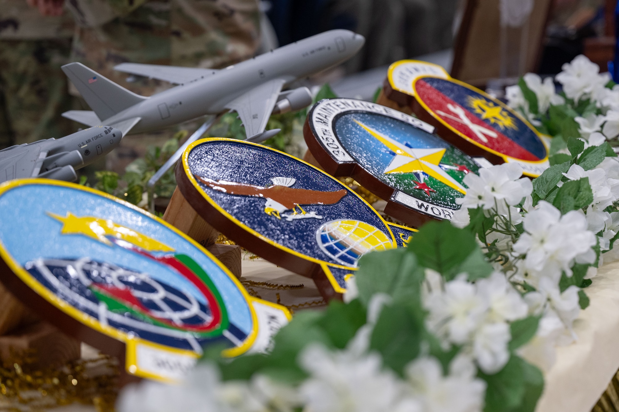 305th Air Mobility Wing squadron emblems are on display during the wing’s Annual Awards Ceremony at Joint Base McGuire-Dix-Lakehurst, N.J., Feb. 23, 2024. Award recipients were recognized for their exceptional performances throughout 2023. (U.S. Air Force photo by Staff Sgt. Monica Roybal)