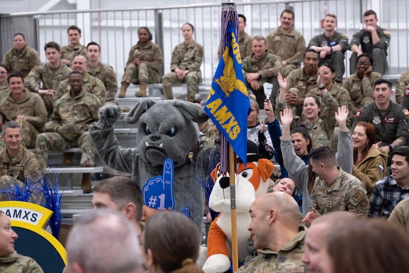 The 305th Aircraft Maintenance Squadron Bulldog mascot and squadron members celebrate their Squadron Rally Cry win during the 305th Air Mobility Wing’s Annual Awards Ceremony at Joint Base McGuire-Dix-Lakehurst, N.J., Feb. 23, 2024. Award recipients were recognized for their exceptional performances throughout 2023. (U.S. Air Force photo by Staff Sgt. Monica Roybal)