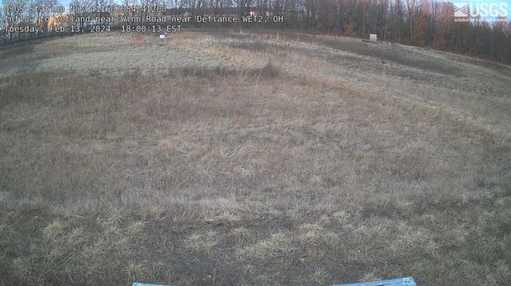 Landscape shot of a brown wetland with text in the upper right and left hand corner.