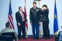 Officer candidate Nick Harrison, District of Columbia National Guard, is pinned the rank of first lieutenant by Baraq Stein, his partner, and Kevin Jennings, CEO of Lambda Legal, during a commissioning ceremony at the D.C. Armory, Aug. 5, 2023.  On Feb. 28, Harrison, a former D.C. National Guard sergeant, completed the Judge Advocate General’s Legal Center and School Officer Basic Course, and will serve within the D.C. National Guard Office of the Staff Judge Advocate (DCNG OSJA).  (Photo courtesy of John Jack Photography)