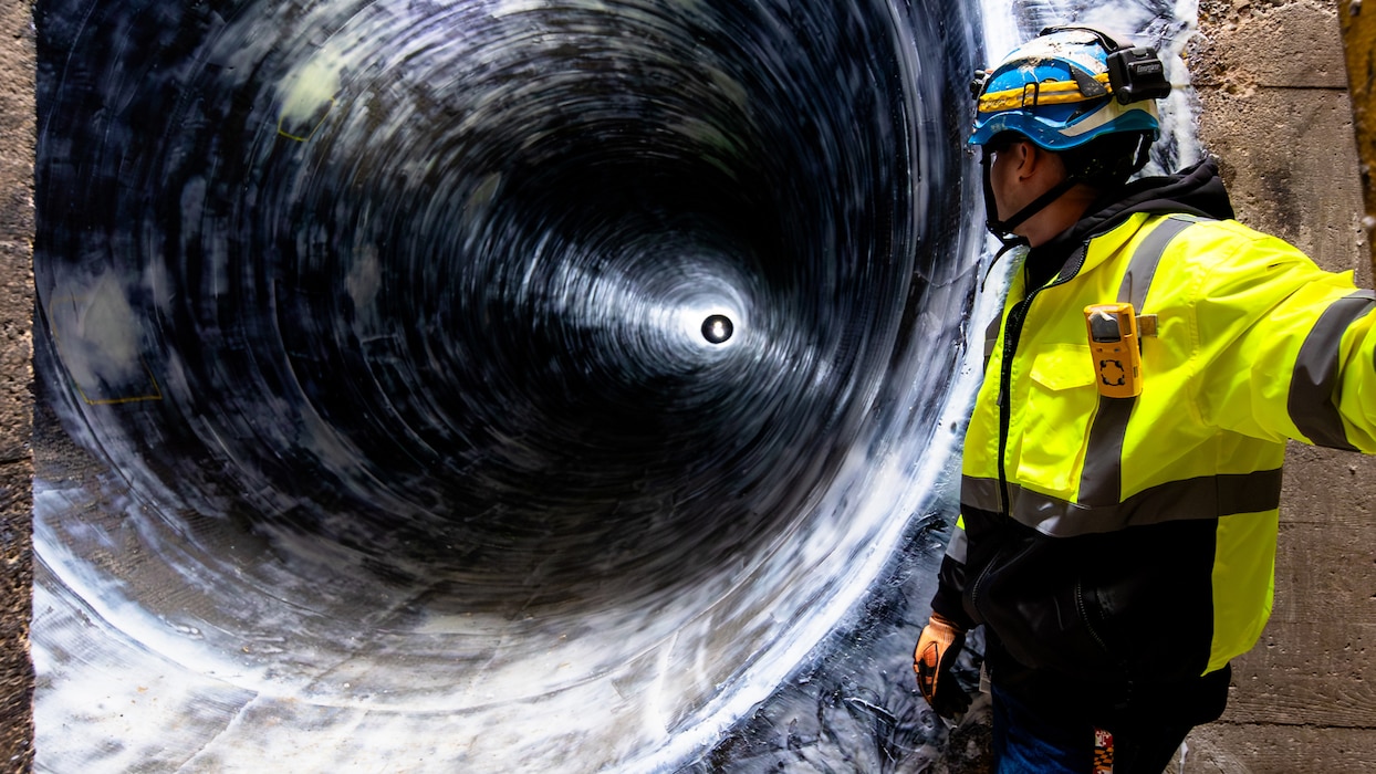 A teammate looks into a 300-foot stretch of the Washington Aqueduct's Old Conduit after it was upgraded with carbon-fiber. Washington Aqueduct crews have been conducting repairs and updates to sections of the utility's First Conduit, commonly referred to as the "Old Conduit," located under MacArthur Boulevard, since November 2023. The Old Conduit is a 12-mile-long circular tube structure carrying water from the Potomac River near Great Falls to the Dalecarlia Reservoir. The conduit was placed in regular service in July 1864 and — thanks to the qualified professionals that have overseen its operations and maintenance throughout the past 160 years — remains a vital component to providing drinking water for approximately 1 million citizens in the DC area.