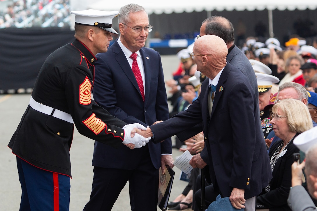 Sergeant Major of the Marine Corps Carlos Ruiz and Gen. Joseph Dunford, U.S. Marine Corps (Ret.) shake hands with Vietnam Veterans who served with Sgt Maj. John L. Canley during the commissioning of the USS John L. Canley at Coronado, Calif., Feb. 17, 2024. The USS John L. Canley (ESB-6) is the first ship to be named after Medal of Honor recipient Sgt Maj. John L. Canley, and the fourth Lewis B. Puller-class expeditionary mobile base of the United States Navy.