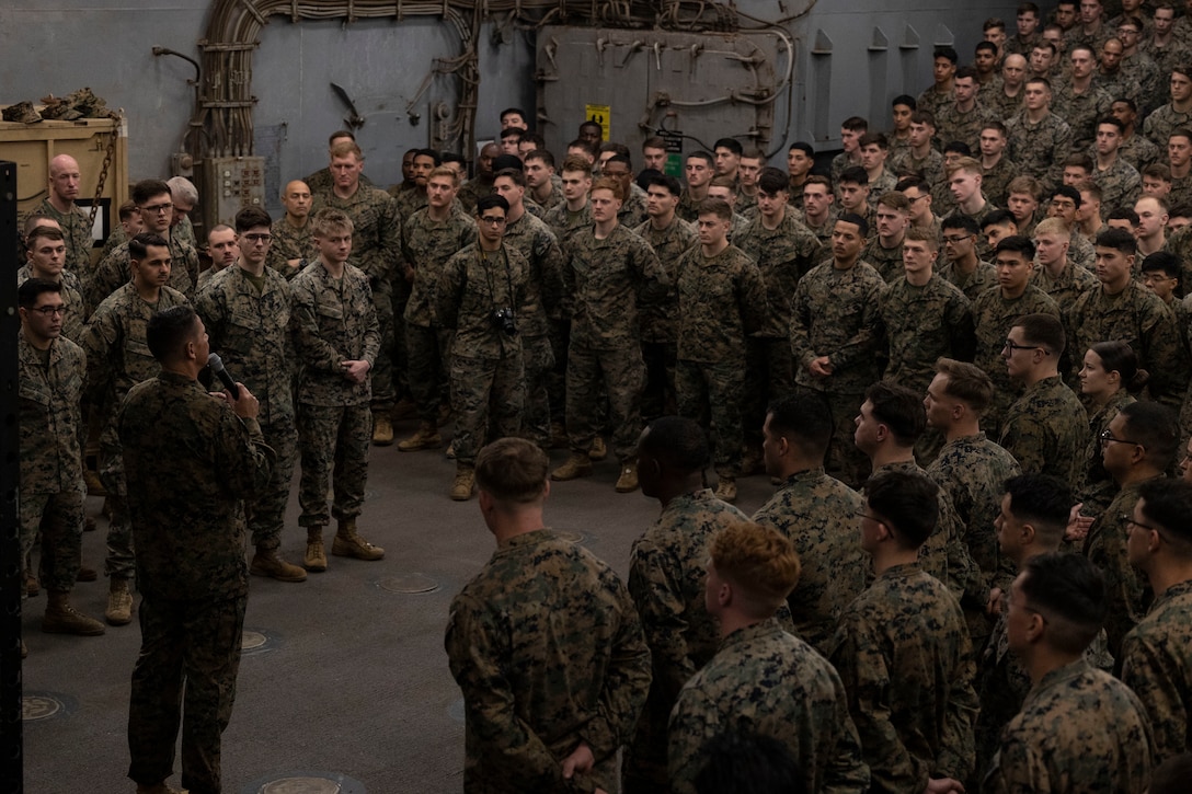 U.S. Marine Corps Sgt. Maj. Carlos A. Ruiz, Sergeant Major of the Marine Corps, addresses Marines and Sailors of the 26th Marine Expeditionary Unit (Special Operations Capable) (MEU(SOC)), during an all-hands formation aboard the Harpers Ferry-class dock landing ship USS Carter Hall (LSD-50), Souda Bay, Greece, March 1, 2024. The 20th Sergeant Major of the Marine Corps visited the forward deployed 26th MEU(SOC) and met with leadership while also hosting discussions with Marines and Sailors. The Bataan Amphibious Ready Group, with the embarked 26th MEU(SOC) is on a scheduled deployment in the U.S. Naval Forces Europe area of operations, employed by U.S. 6th Fleet to defend U.S., Allied and partner interests. (U.S. Marine Corps photo by Cpl. Michele Clarke)